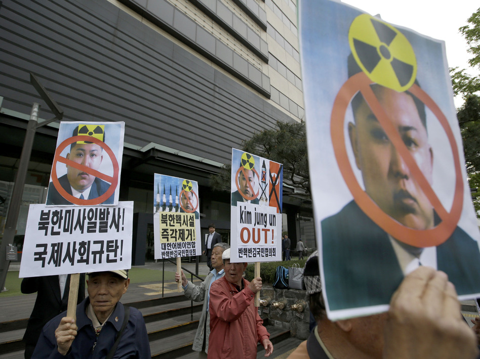 South Korean protesters hold pictures of North Korean leader Kim Jong Un during a rally last week in Seoul. Recent satellite imagery indicates the possibility that Pyongyang is readying for a new nuclear test. Lee Jin-man/AP