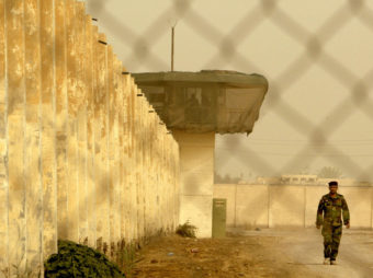 An Iraqi security officer patrols the grounds at Baghdad Central Prison in Abu Ghraib, in 2009. Wathiq Khuzaie/Getty Images