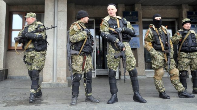 Armed men in military fatigues stood guard Monday outside a regional administration building they seized in the eastern Ukrainian city of Slovyansk. Genya Savilov /AFP/Getty Images