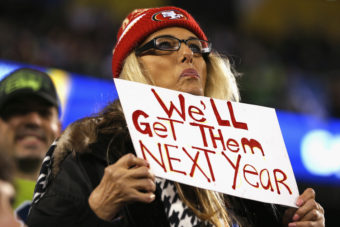 A 49ers fan displays her hopes for next season at a Seahawks game. If a San Francisco fan has his way, the sign could also refer to playoff tickets, which were limited to markets with strong Seattle support this year. Kevin C. Cox/Getty Images