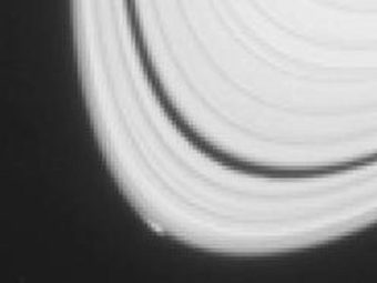 The disturbance visible at the outer edge of Saturn's A ring in this image from NASA's Cassini spacecraft results from gravitational effects on ring particles by an object that may be replaying the birth process of icy moons. NASA/JPL-Caltech/Space Science Institute