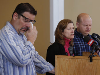 Mindy Corporon speaks during a news conference, flanked by Will Corporon (left) and Tony Corporon, at their church in Leawood, Kan., on Monday. Their father, Dr. William Corporon, and Mindy Corporon's 14-year-old son were killed during Sunday's shooting at the Jewish Community Center in Overland Park, Kan. Orlin Wagner/AP