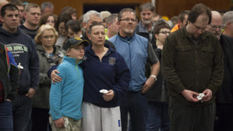 Gabriella Botamanenko (center left) hugs her mother, Angela Botamanenko, during a vigil for mudslide victims at the Darrington Community Center Saturday. A March 22 mudslide in a nearby community killed at least 30 and left many missing. David Ryder/Getty Images