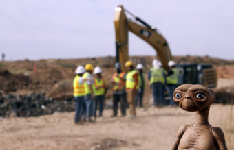 An E.T. doll was held up at the site of an exploratory dig for old Atari video games Saturday. Workers dug into a landfill in Alamogordo, N.M., that had long been rumored to be the final resting place of millions of copies of the game E.T. The Extra-Terrestrial. Juan Carlos Llorca/AP