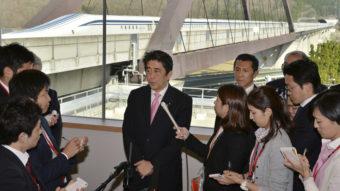 Japanese Prime Minister Shinzo Abe speaks to reporters after inspecting a maglev train system at the Yamanashi Experiment Center in Tsuru Saturday. Japan is reportedly willing to send the technology to the U.S. without a fee. Kazuhiro Nogi/AP