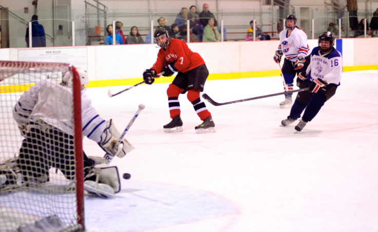 Killer Whales Jason Hort unleashes a shot that Funter Bay goalie Pete Sommers kicks aside in a Tier B title game.