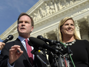 Michigan Attorney General Bill Schuette speaks to reporters after arguing the case before the U.S. Supreme Court in October. He's with XIV Foundation CEO Jennifer Gratz, who was a plaintiff in a lawsuit against the University of Michigan's affirmative action policy. Susan Walsh/AP