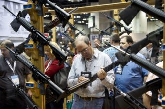 A man examines weapons in the exhibit hall at the 143rd NRA Annual Meetings and Exhibits at the Indiana Convention Center in Indianapolis. Karen Bleier/AFP/Getty Images