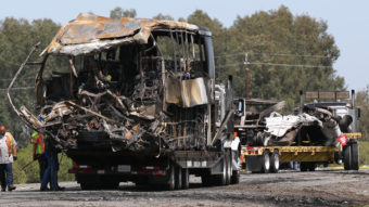 The remains of a FedEx truck (right) and a bus involved in a crash Thursday are taken from the scene of the accident in Orland, Calif., by flatbed trucks on Friday. The students had been on their way to visit Humboldt State University in Northern California. Elijah Nouvelage /Getty Images
