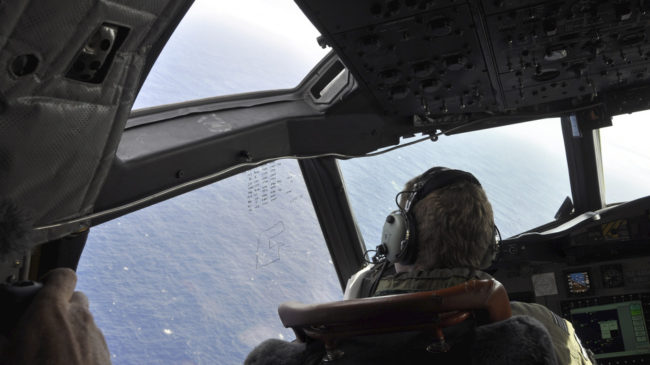 A crewman on a Royal New Zealand Air Force P-3 Orion searches for possible debris from the missing Malaysia Airlines Flight 370, in the southern Indian Ocean earlier this month. Kim Christian/AP