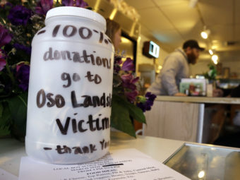 In Arlington, Wash., neighbors and businesses are raising money for the families of those affected by the mudslide in Oso, a part of that city. Elaine Thompson/AP