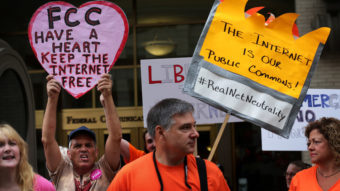 Demonstrators protest outside the Federal Communications Commission Thursday. The agency voted to open new proposed rules for public comment, including a discussion of whether "paid prioritization" should be banned. Alex Wong/Getty Images