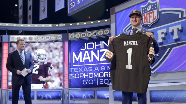 Texas A&M quarterback Johnny Manziel poses for photos after being selected by the Cleveland Browns as the 22nd pick in the first round of the 2014 NFL Draft, Thursday. Craig Ruttle/AP