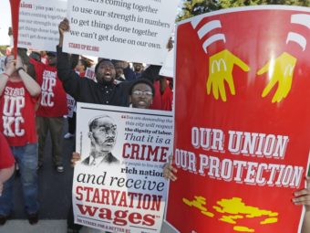 Hundreds of workers, organizers and supporters gather outside McDonald's Corp. on Thursday, in Oak Brook, Ill., calling for $15 an hour and the right to unionize. M. Spencer Green/AP