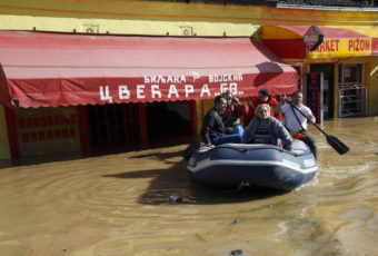 Volunteers use a rubber boat to evacuate residents from a flooded area in Obrenovac, some 18 miles southwest of Belgrade, Serbia on Sunday. Darko Vojinovic/AP