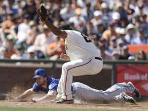 New York Mets' Daniel Murphy slides to score in a game against San Francisco on Sunday. Murphy, who spoke at a White House discussion on Monday, was heavily criticized earlier this year for missing the first two games of the season to be on hand for the birth of his son. Ben Margot/AP