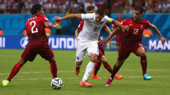 Clint Dempsey of the United States is challenged by Portugal's Bruno Alves (left) and Ricardo Costa during the 2014 FIFA World Cup Group G match Sunday in Brazil. Warren Little/Getty Images