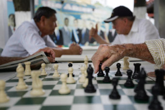 A elderly man makes a move on a chess board at the Maximo Gomez Domino park in Little Havana in Miami, where political opinions are shifting. Roberto Schmidt /AFP/Getty Images