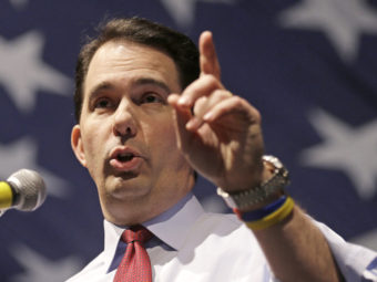 Wisconsin Republican Gov. Scott Walker speaks in Milwaukee in May. Newly released documents show prosecutors are alleging Walker was at the center of a nationwide "criminal scheme" to illegally coordinate with outside conservative groups. Jeffrey Phelps/AP