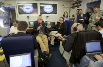 Defense Secretary Chuck Hagel, center, speaks to members of the media aboard a U.S. military aircraft on Sunday. Hagel said quick action was necessary to save Sgt. Bowe Bergdahl's life, leaving no time to disclose the administration's plans to Congress. Pablo Martinez Monsivais/AP