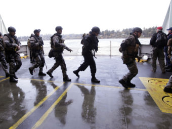 During a drill, SWAT team members prepare to secure a ship in Bainbridge Island, Wash. Elaine Thompson/AP