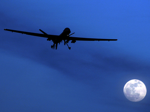 An unmanned U.S. Predator drone flies over Kandahar Air Field, southern Afghanistan, on Jan. 31, 2010. U.S. drone strikes killed at least 13 people in two separate strikes Wednesday and Thursday in Pakistan's tribal area. Kirsty Wigglesworth/AP