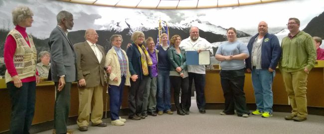 Supporters pose with Mayor Merrill Sanford after he read a proclamation declaring June 2014 as Juneau Pride 2014. It's a celebration of LGBT people and their contributions. (Photo by Jeremy Hsieh/KTOO)