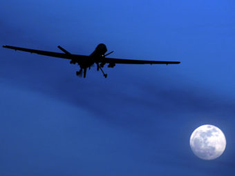 An unmanned U.S. Predator drone flies over Kandahar Air Field, southern Afghanistan, in 2010. A new report questions the U.S. policy of using armed drones abroad to carry out attacks on suspected terrorists. Kirsty Wigglesworth/AP