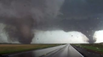A still image from a video shows two tornadoes approaching Pilger, Neb., Monday. The National Weather Service said at least two people died in the large storm that hit northeast Nebraska. StormChasingVideo.com/AP