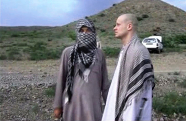 In this file image taken from video obtained from Voice Of Jihad Website, which has been authenticated based on its contents and other AP reporting, Sgt. Bowe Bergdahl (right) stands with a Taliban fighter in eastern Afghanistan. AP