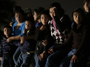 Immigrants from Honduras and El Salvador who crossed the U.S.-Mexico border illegally are stopped in Granjeno, Texas, on June 25. President Obama asked Congress this week for $3.7 billion to cope with thousands of minors from Central America who are illegally crossing the U.S. border. Eric Gay/AP