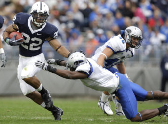 Penn State running back Evan Royster eludes a tackle by Eastern Illinois' Adrian Arrington during a 2009 NCAA college football game in State College, Pa. Arrington was one of the athletes who sued the NCAA over concussions. Carolyn Kaster/AP