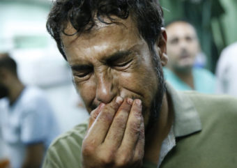 A Palestinian man cries after bringing a child, wounded in a strike on a compound housing a U.N. school in Beit Hanoun, in the northern Gaza Strip, to the emergency room of the Kamal Adwan hospital in Beit Lahiya on Thursday. Lefteris Pitarakis/AP
