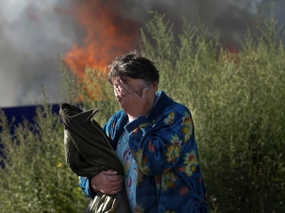 A woman cries near her burning house after shelling in the city of Slovyansk, Donetsk Region, eastern Ukraine, last month. The city of 100,000 has now been retaken from pro-Russian separatists. Dmitry Lovetsky/AP
