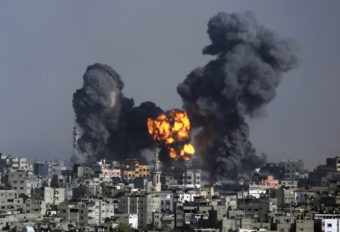 Smoke and fire from the explosion of an Israeli strike rise over Gaza City on Tuesday. Israeli airstrikes pummeled a wide range of locations along the coastal area as diplomatic efforts intensified to end the two-week war. Hatem Moussa/AP