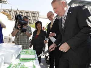 Seattle Mayor Ed Murray (right) and Seattle City Council President Tim Burgess cut a cake to celebrate city's raised minimum wage. Ted S. Warren/AP