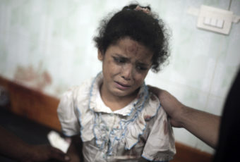 A Palestinian girl cries while receiving treatment for her injuries caused by an Israeli strike at a U.N. school in Jebaliya refugee camp, at the Kamal Adwan hospital in Beit Lahiya on Wednesday. Khalil Hamra/AP