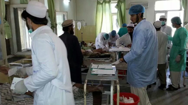 Afghan doctors assist civilians wounded by a suicide bomber in Paktika province on Tuesday. Uncredited/AP