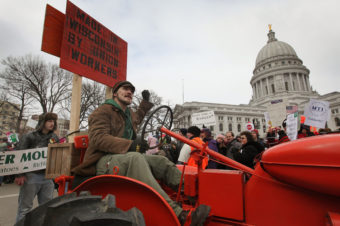 A farmer drives his tractor past the Wisconsin State Capitol during a rally in March of 2011. Scott Olson/Getty Images