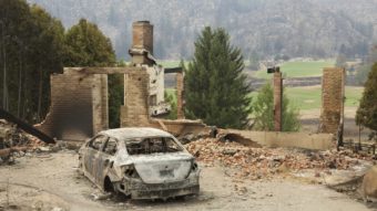 A burned-out car sits in front of a ruined house in this photo taken Sunday near Pateros, Wash. Large fires have destroyed hundreds of homes in the state this month. Stephen Brashear/Getty Images