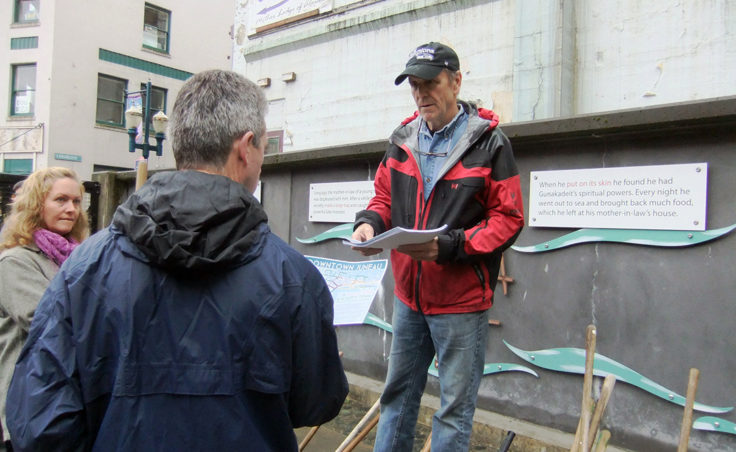Bruce Denton hands out information to volunteers. (Photo by Rosemarie Alexander/KTOO)