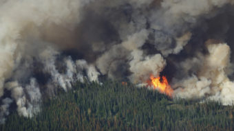 Smoke and flames rise from the Chiwaukum Creek Fire near Leavenworth, Wash., Thursday in this aerial photo. Ted S. Warren/AP