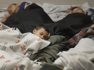 Detainees sleep in a holding cell at a U.S. Customs and Border Protection processing facility in Brownsville, Texas, on June 18. The White House on Tuesday sought $3.7 billion to deal with the immigration crisis at the border. Eric Gay/AP