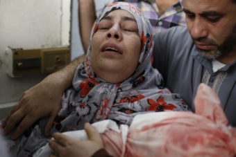 The grief-stricken Palestinian mother of 1-year-old Abdulrahamn Abed al-Nabi carries his body after he was killed in an Israeli military strike along with their cousin, 3-year-old Hadi Abed al-Nabi. Mohammed Abed/AFP/Getty Images