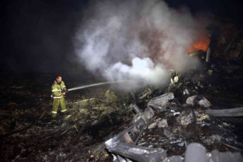 A firefighter sprays water to extinguish a fire amid the wreckage from the Malaysian airliner crash in eastern Ukraine on Thursday. A Malaysia Airlines Boeing 777 with 295 passengers and crew aboard crashed near the Donetsk area of Ukraine that has been wracked by a separatist insurgency. Alexander Khudoteply/AFP/Getty Images