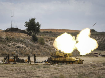 An Israeli artillery shell is fired at the border with Gaza on Friday near Sderot, Israel. Late last night Israeli forces escalated their operation with a ground offensive, sending troops into Gaza. More than 250 Palestinians have lost their lives since Israel began operation 'Protective Edge'. Ilia Yefimovich/Getty Images