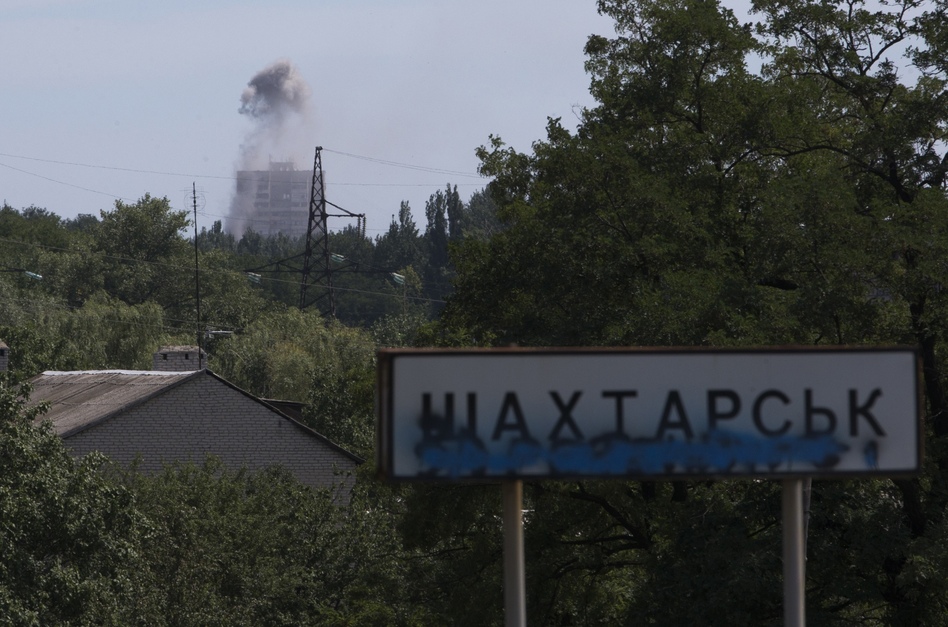 Smoke from shelling rises over a residential apartment house in Shakhtarsk, which is in the Donetsk region of Ukraine, on Monday. Dmitry Lovetsky/AP