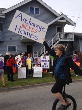 Residents protest in front of a home slated for removal for the proposed Knik Arm Bridge. (Photo by Anne Hillman/KSKA)