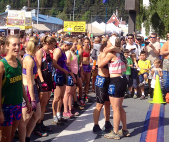 Holly Brooks hugs fellow competitor Charlotte Edmondson before race. (Photo by Alexandra Gutierrez, APRN – Seward)