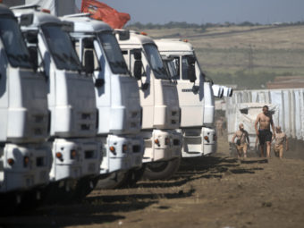 A convoy purportedly carrying humanitarian aid is parked about 17 miles from Ukrainian border, Rostov-on-Don region, Russia, on Friday. Ukrainian officials have insisted on inspecting the cargo over fears that the convoy might be a pretext for invasion. Pavel Golovkin/AP